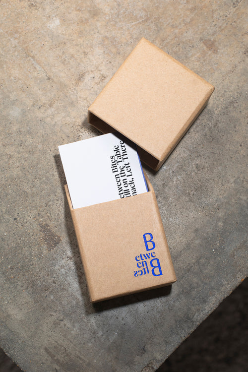 Business card mockup in packaging on a raw concrete table.