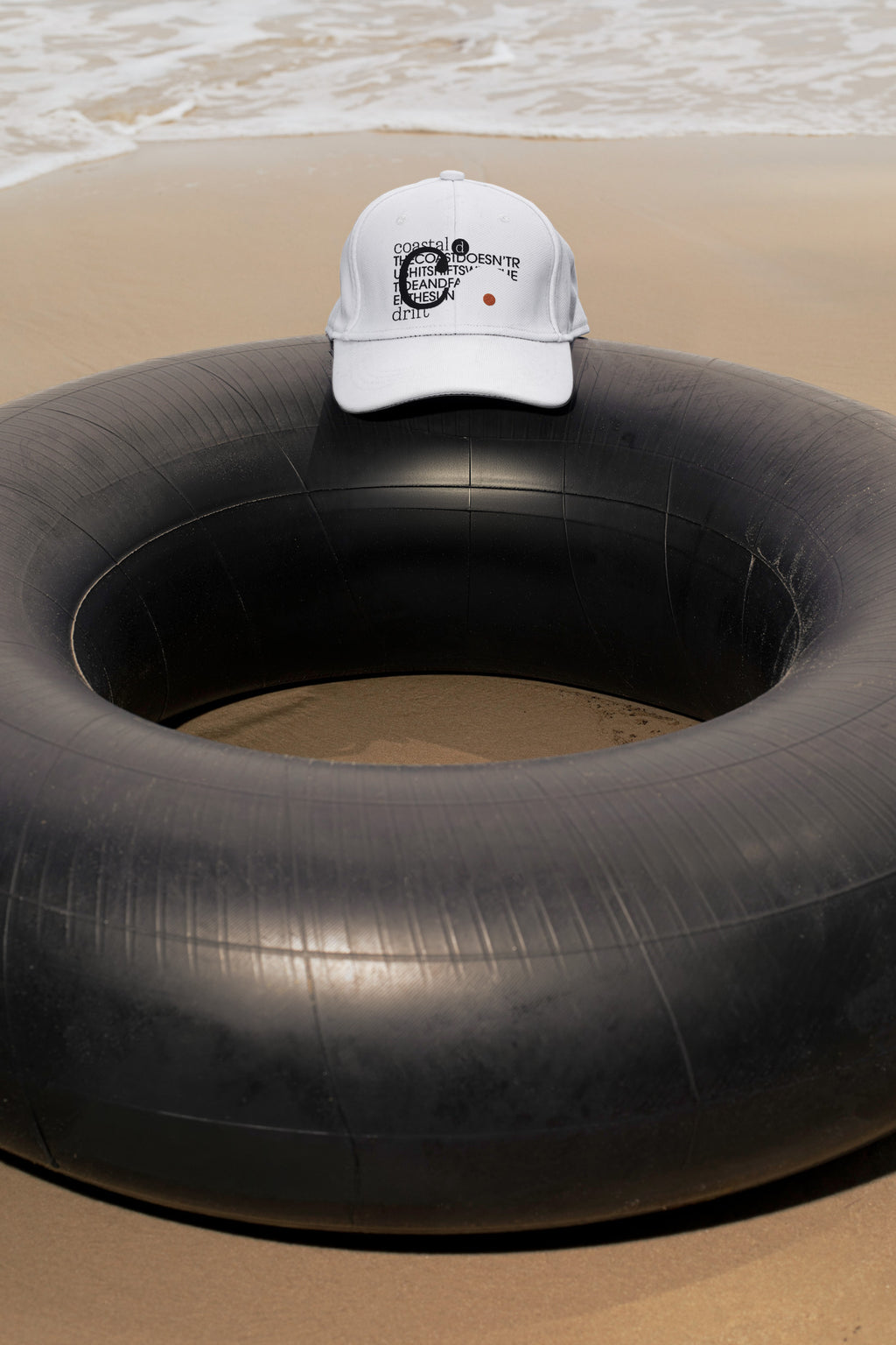 Cap mockup placed on a traditional Thai inner tube float at the beach in Hua Hin, Thailand. Choose between a realistic embroidery effect or a clean graphic application.