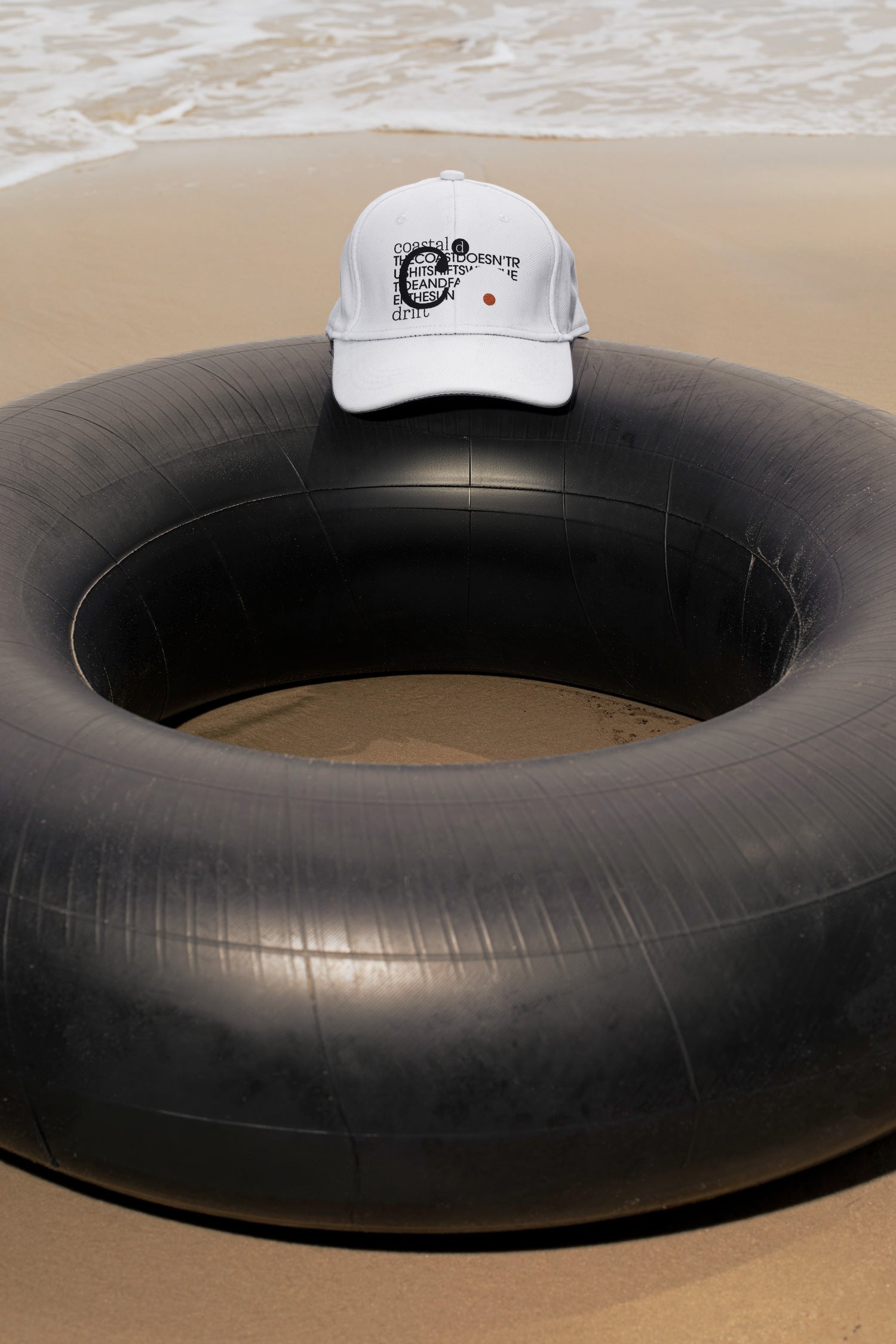 Cap mockup placed on a traditional Thai inner tube float at the beach in Hua Hin, Thailand. Choose between a realistic embroidery effect or a clean graphic application.