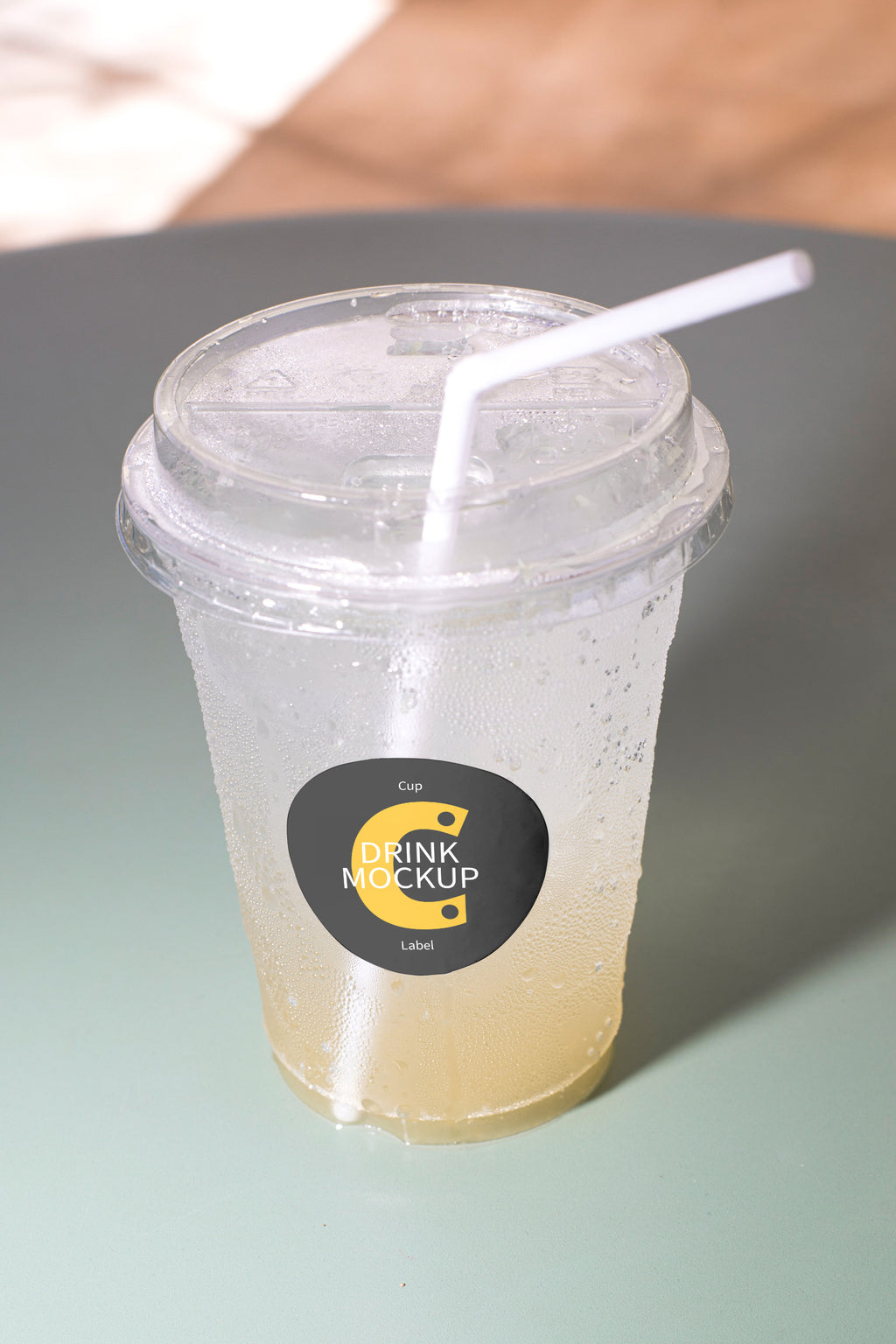 Takeaway drink mockup resting on a chair, featuring a customizable label. Built for showcasing beverage brands, packaging, cafés, restaurants, and lifestyle concepts.