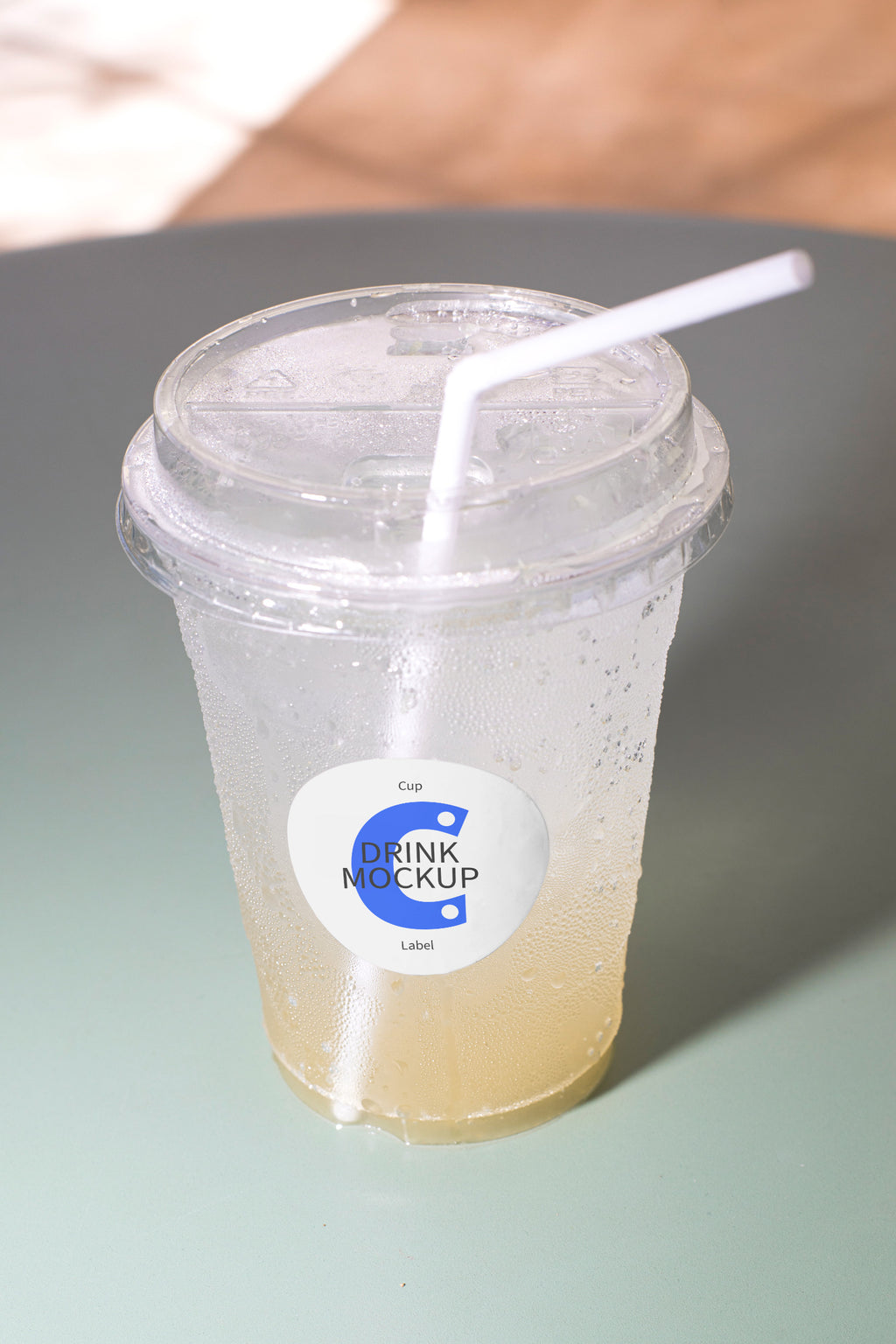 Takeaway drink mockup resting on a chair, featuring a customizable label. Built for showcasing beverage brands, packaging, cafés, restaurants, and lifestyle concepts.