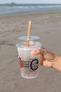 Plastic cup mockup held by hand at the beach. Built for showcasing beverage branding, logos, packaging, and summer lifestyle concepts.