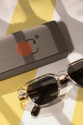 Eyewear case mockup resting on a beach towel beside sunglasses in Hua Hin, Thailand. Built for showcasing eyewear brands, fashion accessories, lifestyle products, and premium branding concepts.