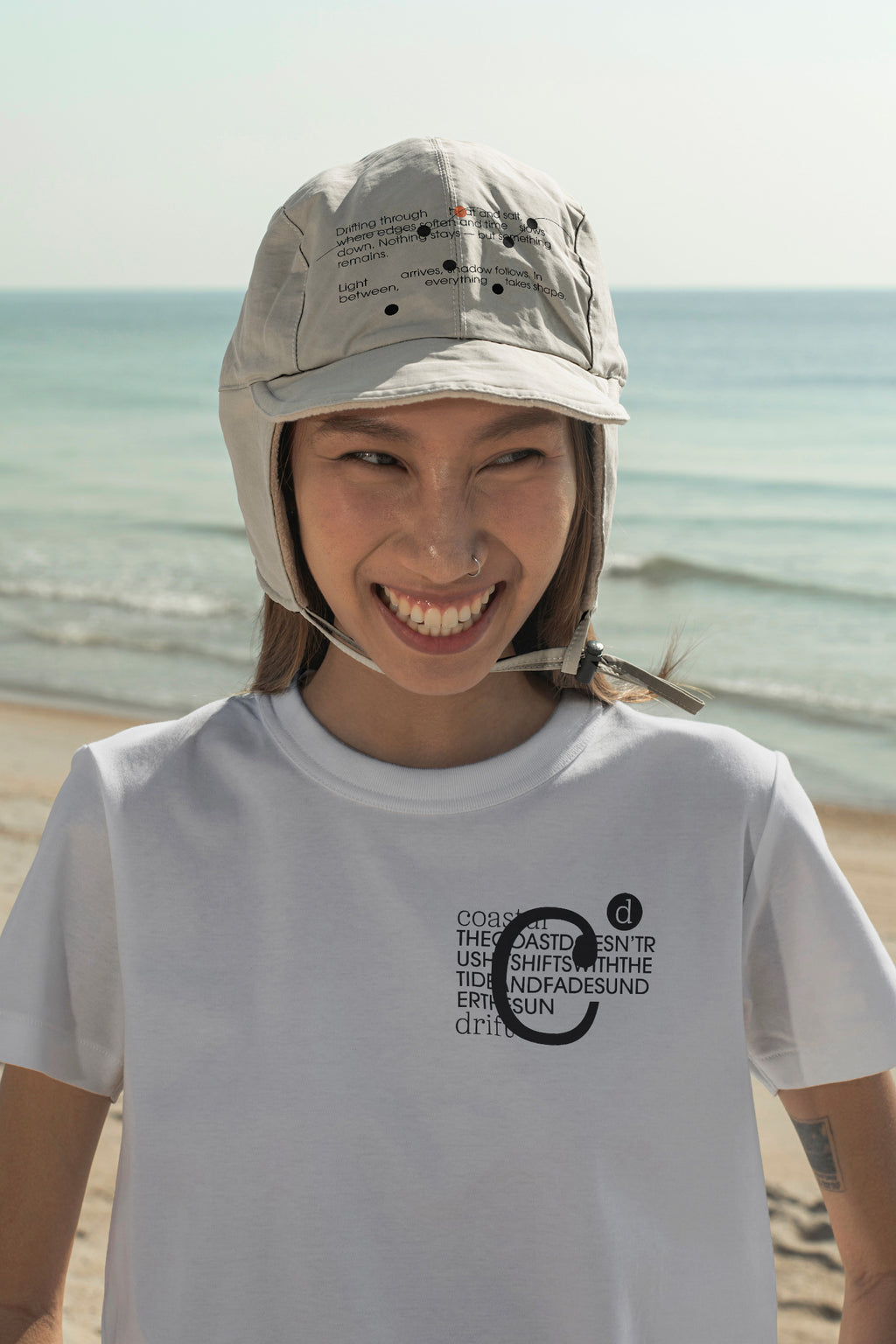 Aviation flap cap and T-shirt mockups worn by local creative Nae along the coast of Hua Hin, Thailand. Built for showcasing apparel brands, fashion collections, and lifestyle identities.