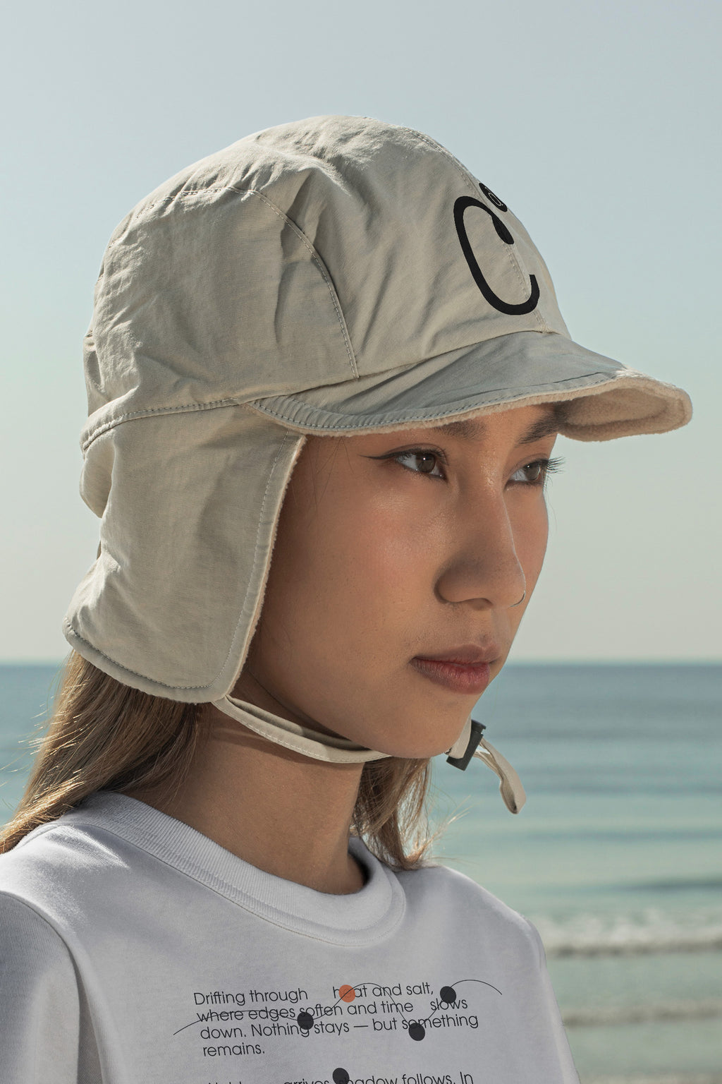 Aviation flap cap and T-shirt mockups worn by local creative Nae along the coast of Hua Hin, Thailand. Built for showcasing apparel brands, fashion collections, and lifestyle identities.