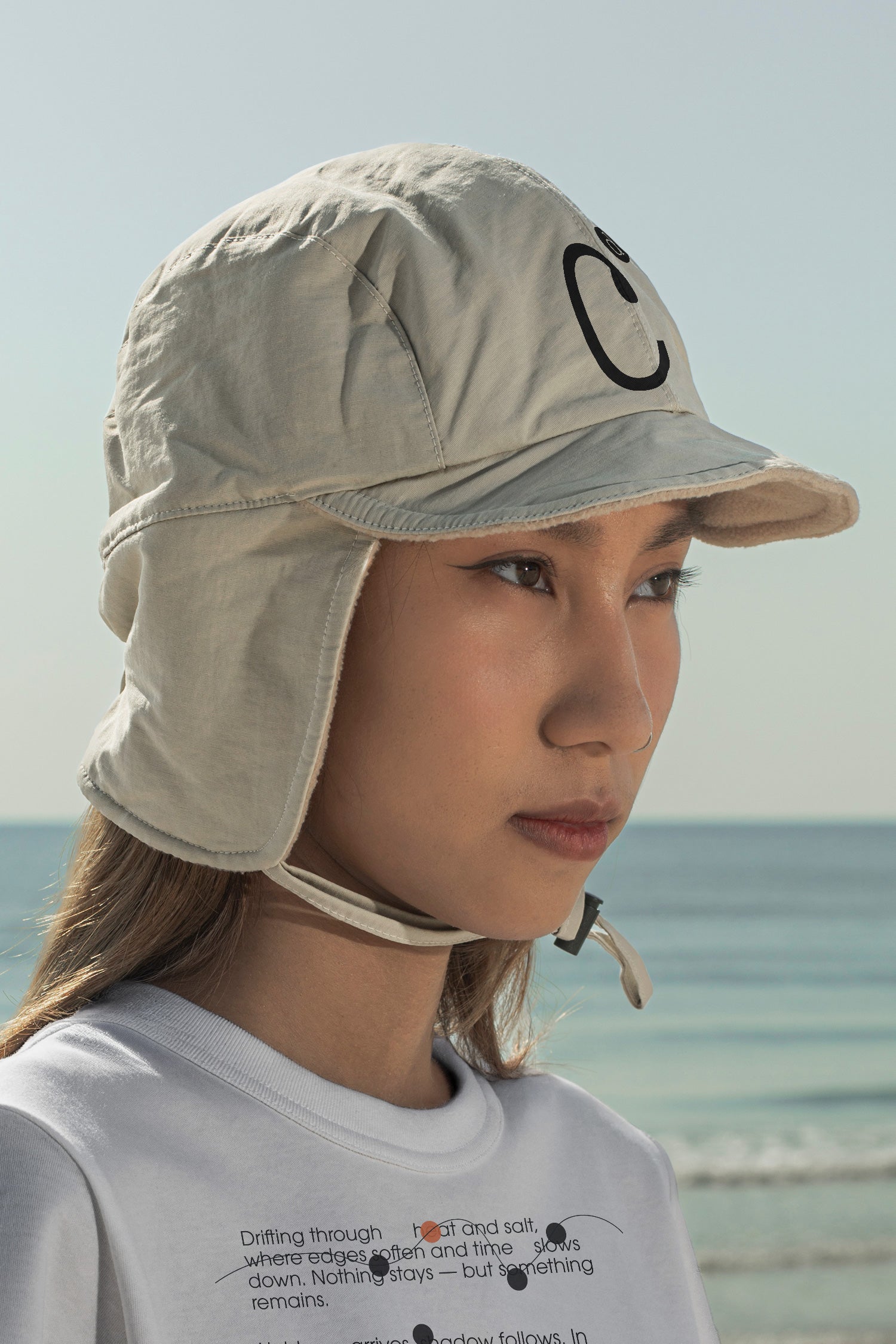 Aviation flap cap and T-shirt mockups worn by local creative Nae along the coast of Hua Hin, Thailand. Built for showcasing apparel brands, fashion collections, and lifestyle identities.