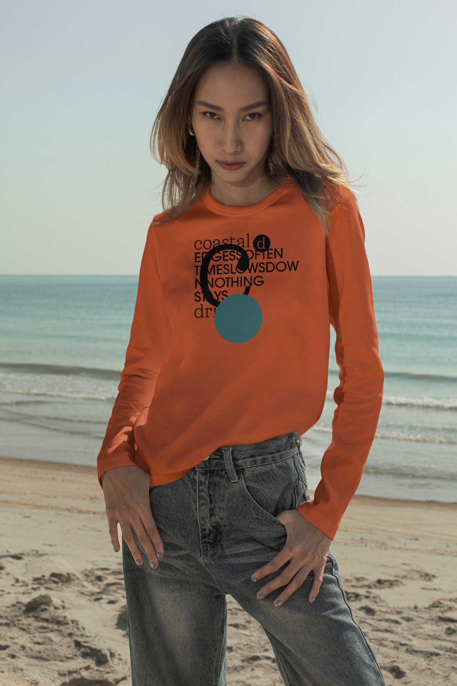 Long sleeve T-shirt mockup worn with jeans at the beach in Hua Hin, Thailand. Built for showcasing apparel brands, fashion graphics, merchandise, and lifestyle identities.