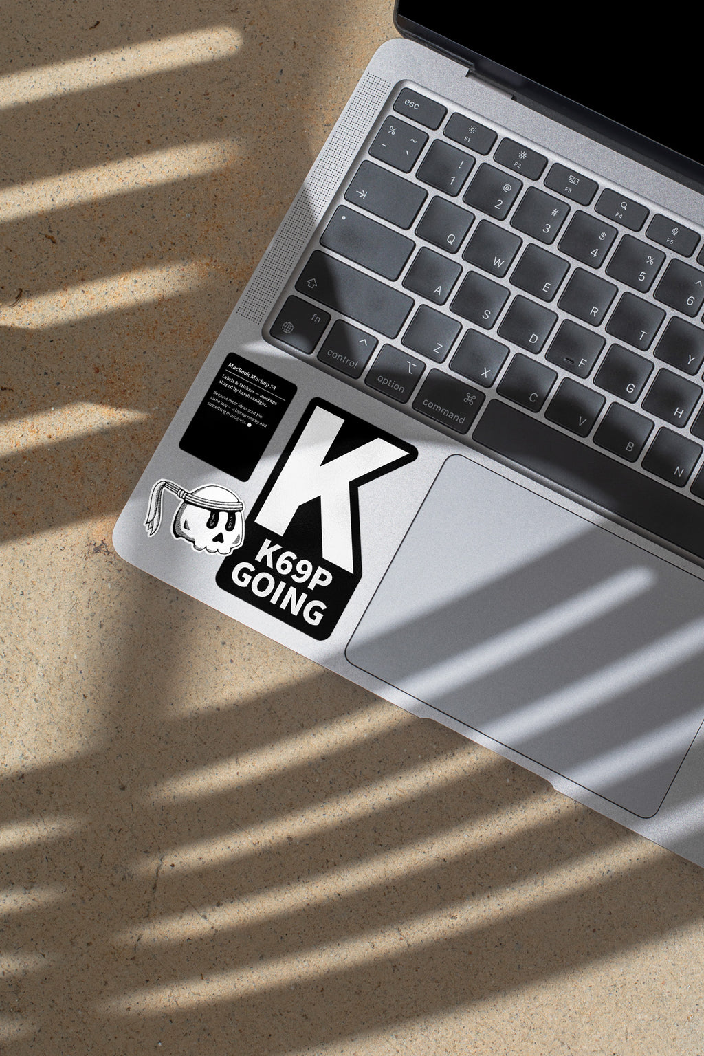 MacBook mockup shaped by harsh sunlight, featuring labels and stickers placed directly on the laptop.