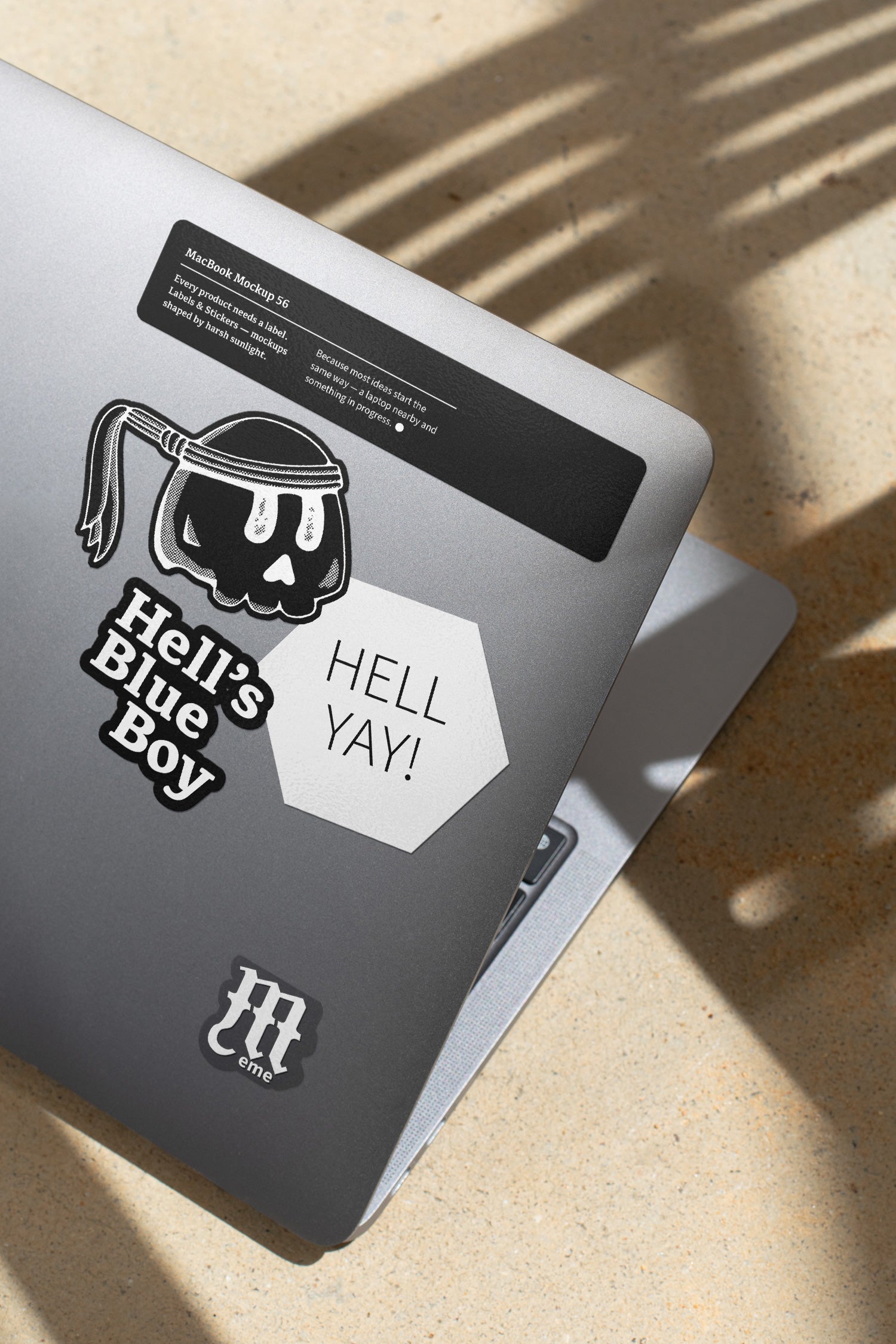 MacBook mockup shaped by harsh sunlight, featuring labels and stickers placed directly on the laptop.