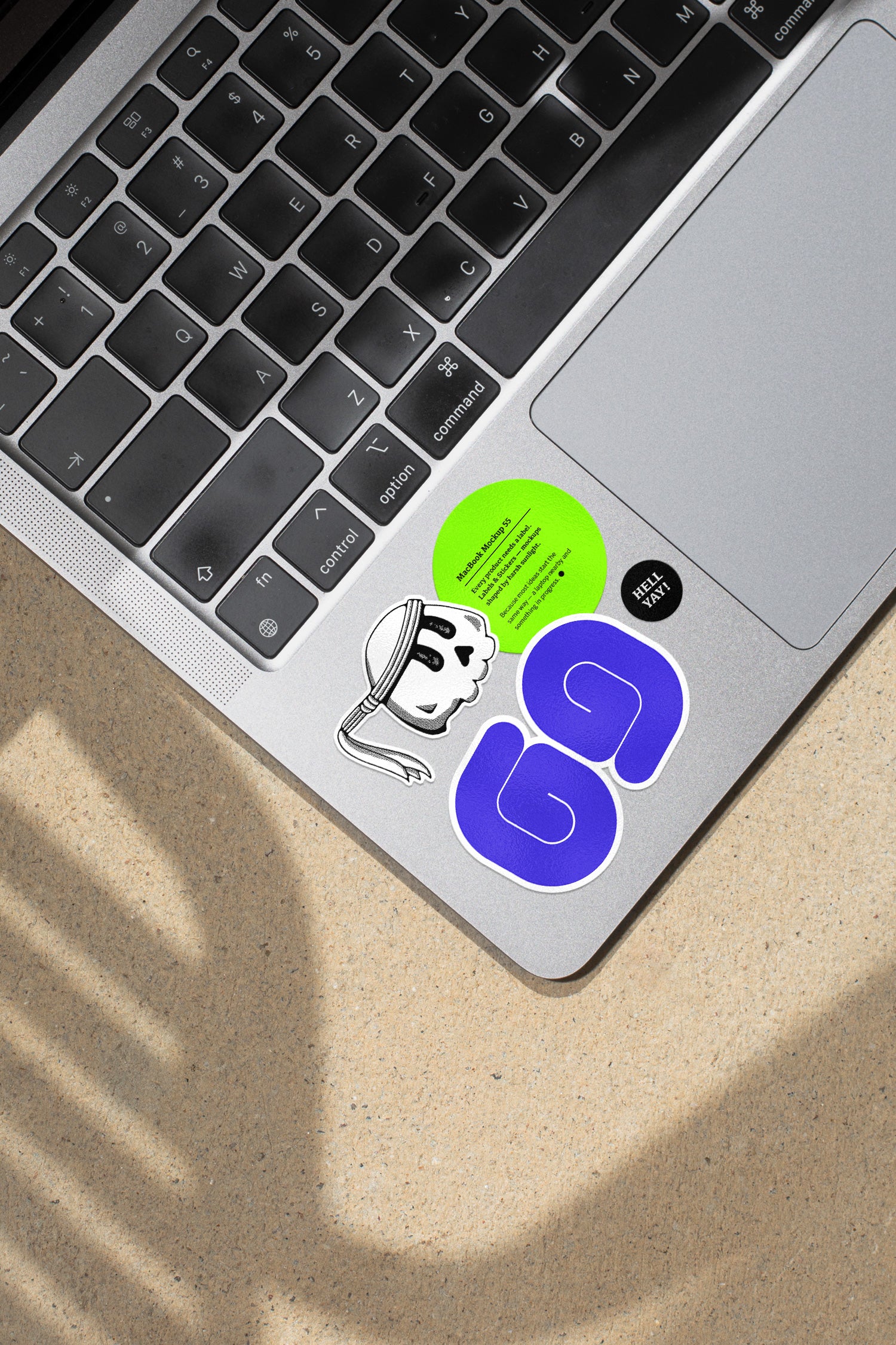 MacBook mockup shaped by harsh sunlight, featuring labels and stickers placed directly on the laptop.