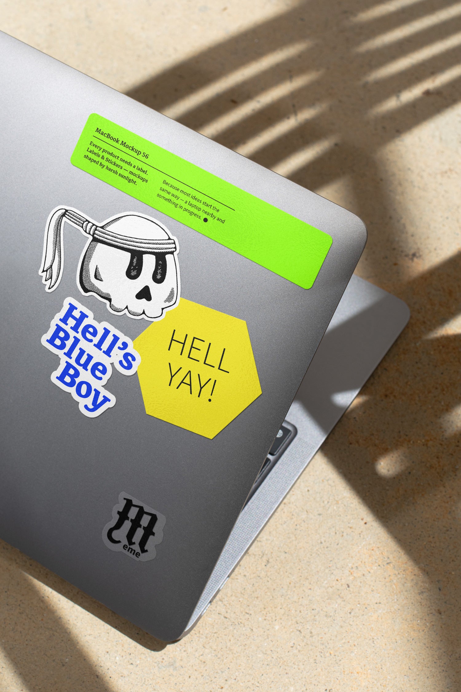 MacBook mockup shaped by harsh sunlight, featuring labels and stickers placed directly on the laptop.