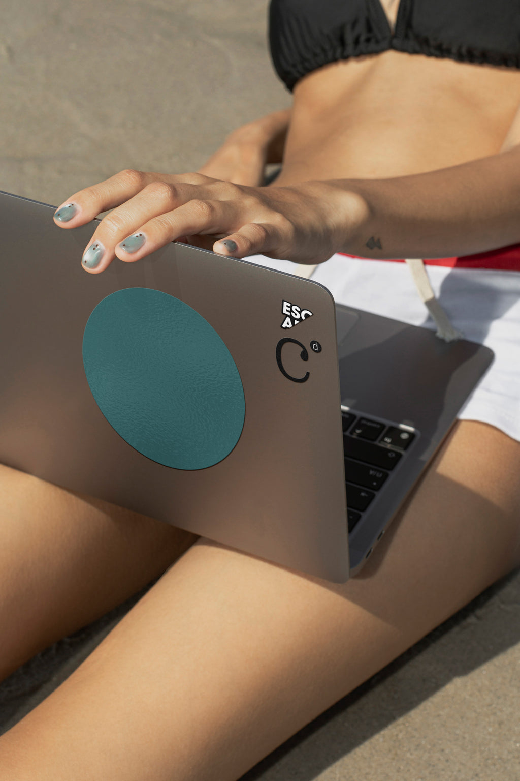 MacBook mockup resting on the lap while sitting in shallow beach water. Built for showcasing websites, user interfaces, branding, presentations, and creative workflows.