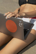 MacBook mockup resting on the lap while sitting in shallow beach water. Built for showcasing websites, user interfaces, branding, presentations, and creative workflows.