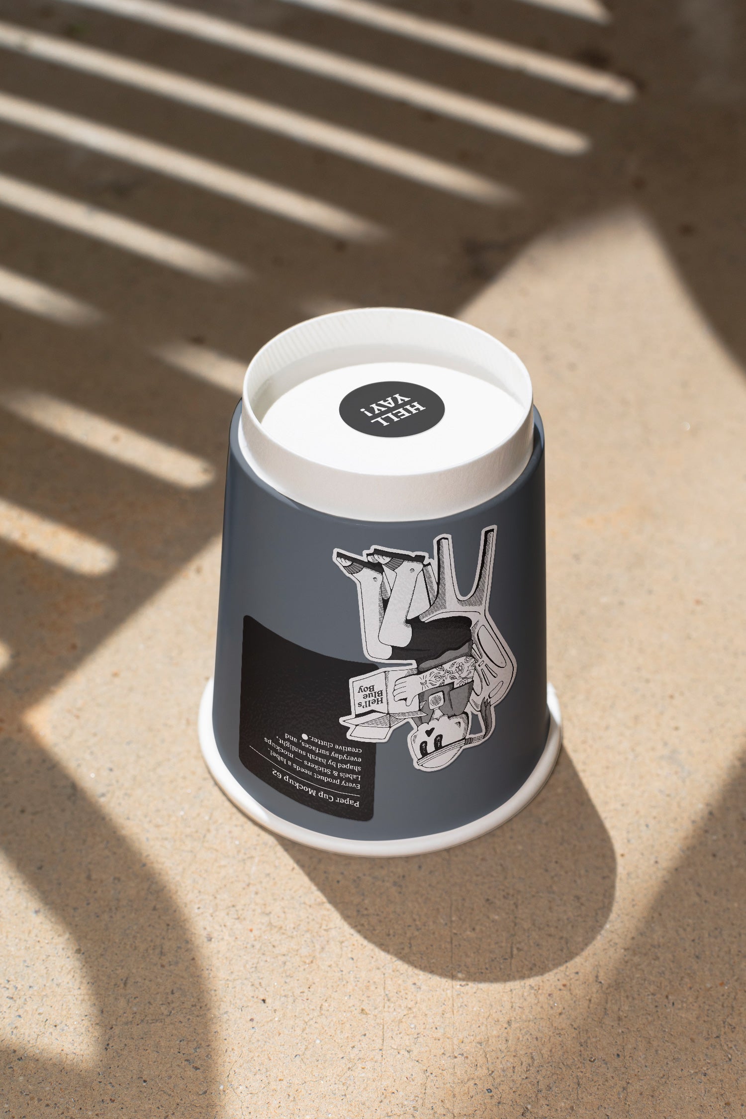 Paper coffee cup mockup featuring stickers placed directly on the cup, photographed under harsh sunlight.