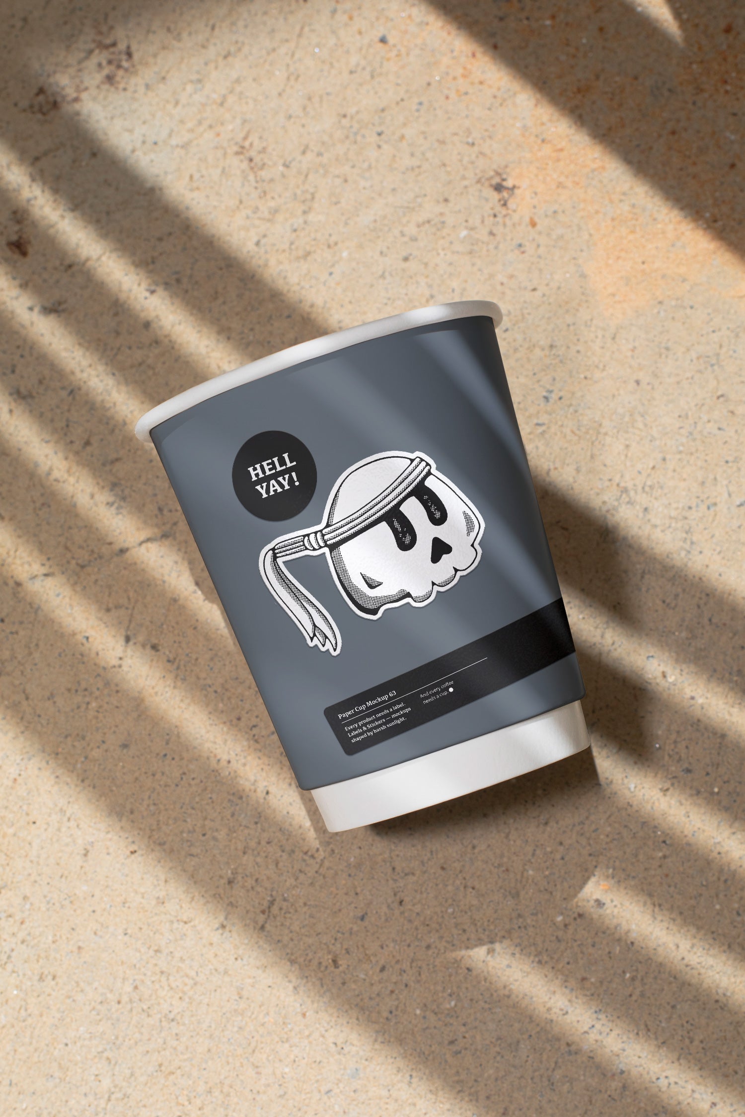 Paper coffee cup mockup featuring stickers placed directly on the cup, photographed under harsh sunlight.