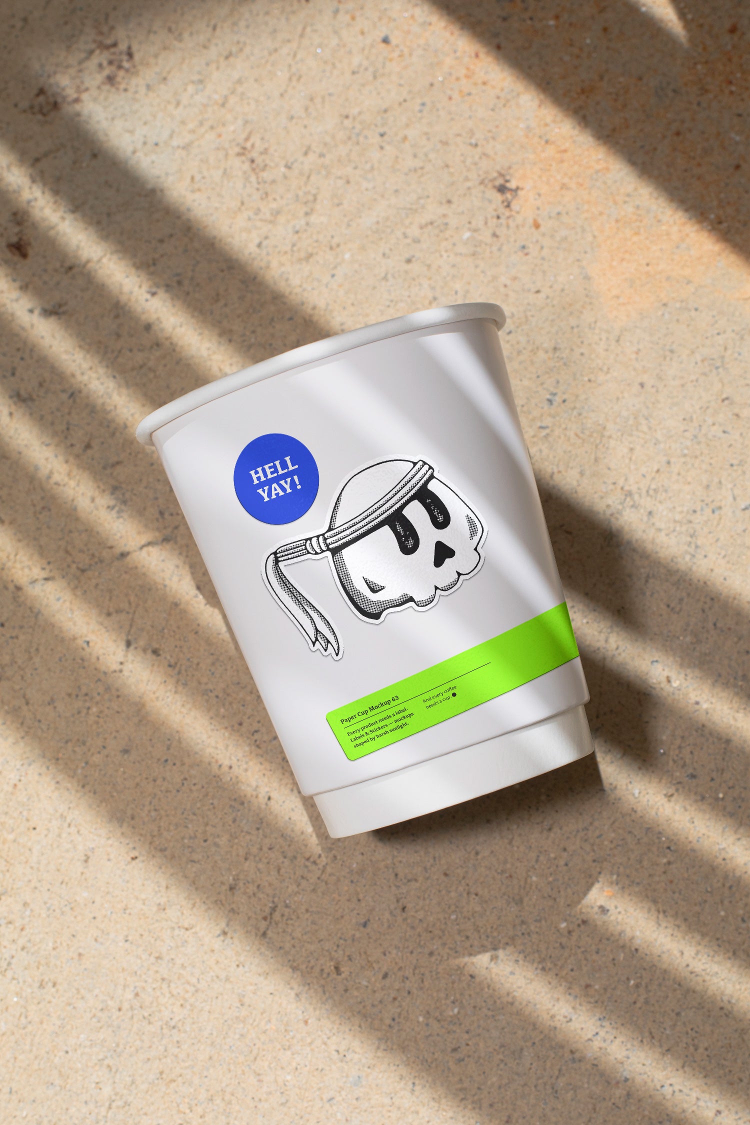 Paper coffee cup mockup featuring stickers placed directly on the cup, photographed under harsh sunlight.