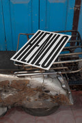 Poster mockup lying on the backpack of a vintage silver Vespa.