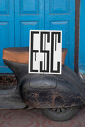 Poster mockup leaning against a vintage black Vespa.