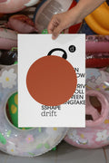 Poster mockup held by hand against a backdrop of several colorful plastic swim rings. Built for showcasing posters, editorial layouts, typography, branding, and print concepts.