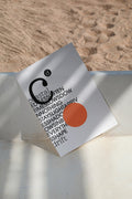 Poster mockup resting on bench against a sandy beach backdrop. Built for showcasing posters, editorial layouts, typography, branding, and print concepts.