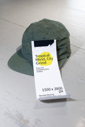 Cashier receipt mockup placed on a white wooden table with a green cap.