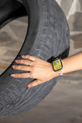 Lifestyle smartwatch mockup featuring a woman’s hand with jewelry wristband holding an SUV tire.