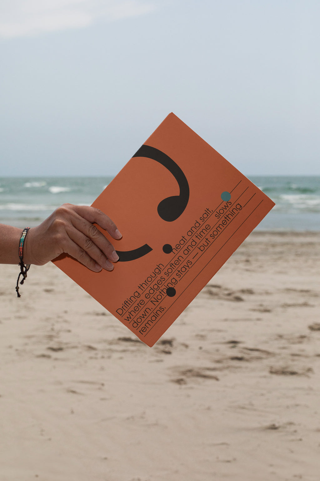 Softcover magazine mockup showing the back cover against a sandy beach backdrop. Built for showcasing editorial layouts, magazine branding, photography, and print concepts.