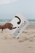 Softcover magazine mockup showing the back cover against a sandy beach backdrop. Built for showcasing editorial layouts, magazine branding, photography, and print concepts.