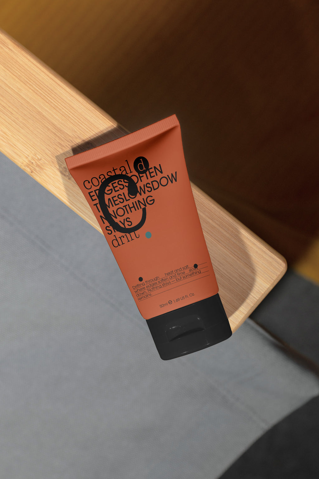 Sunscreen tube mockup resting on the wooden armrest of a beach chair. Built for showcasing cosmetic packaging, skincare brands, wellness products, and lifestyle concepts.