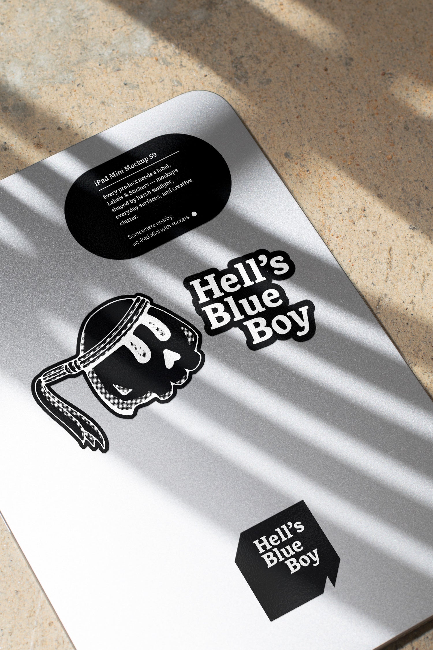 iPad Mini mockup shaped by harsh sunlight, featuring labels and stickers placed directly on the device.