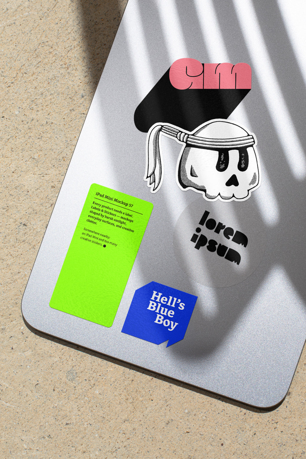 iPad Mini mockup shaped by harsh sunlight, featuring labels and stickers placed directly on the device.