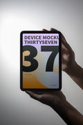 iPad Mini mockup held in hand against a light background.