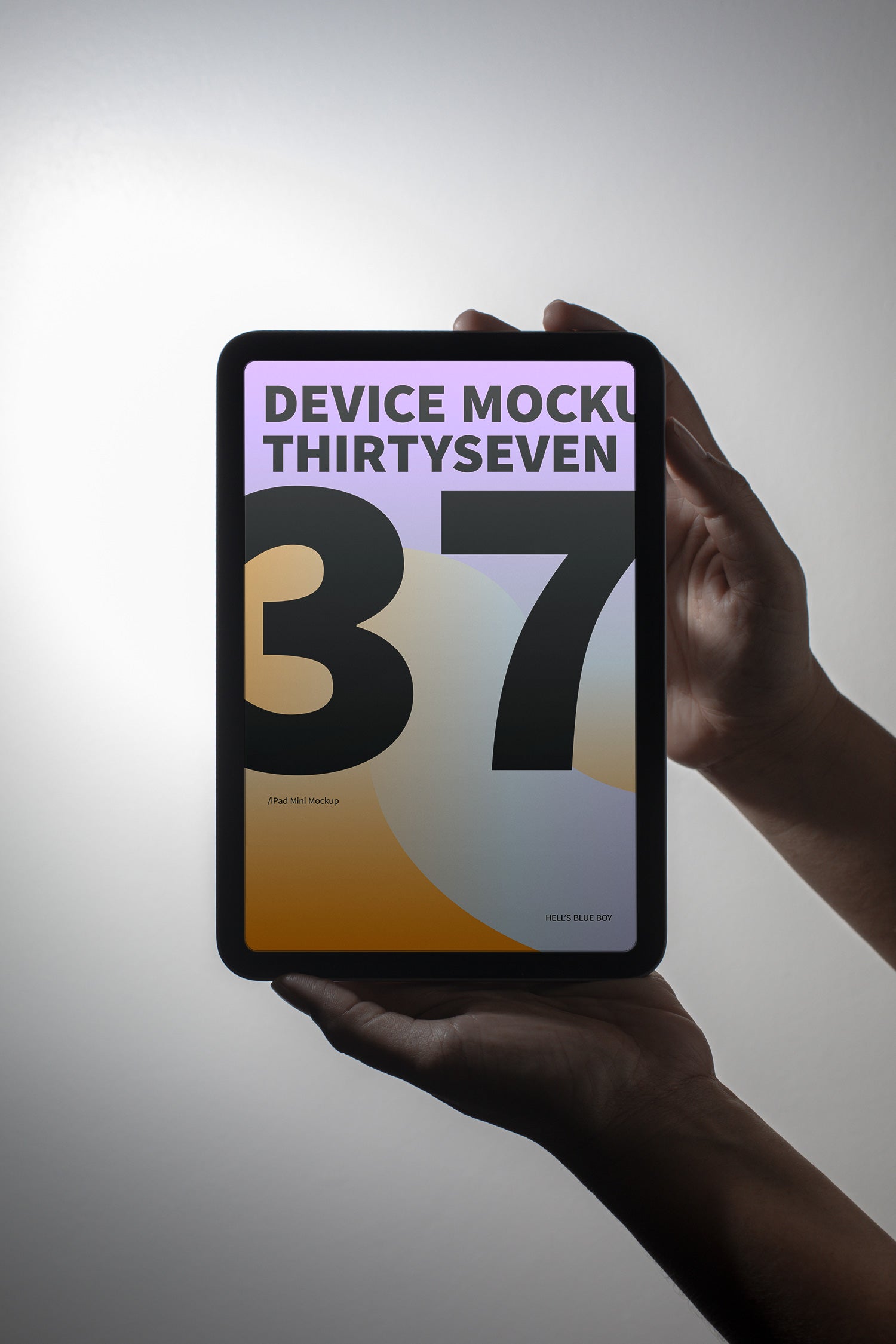 iPad Mini mockup held in hand against a light background.