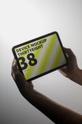 iPad Mini mockup held in hand against a light background.