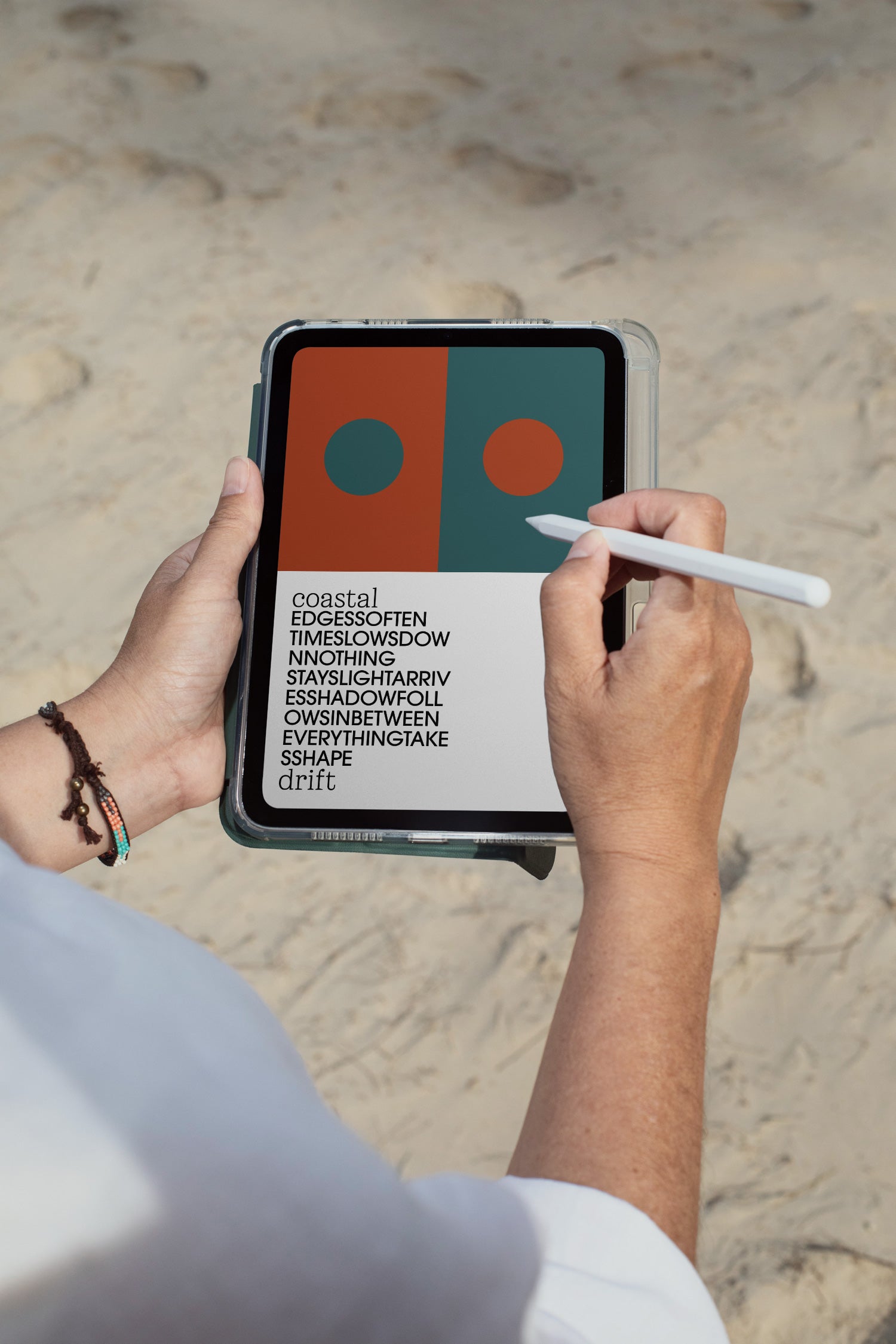 iPad mockup held by hand with pen against a sandy beach backdrop in Hua Hin, Thailand. Built for showcasing app interfaces, branding, editorial layouts, illustrations, and creative presentations.
