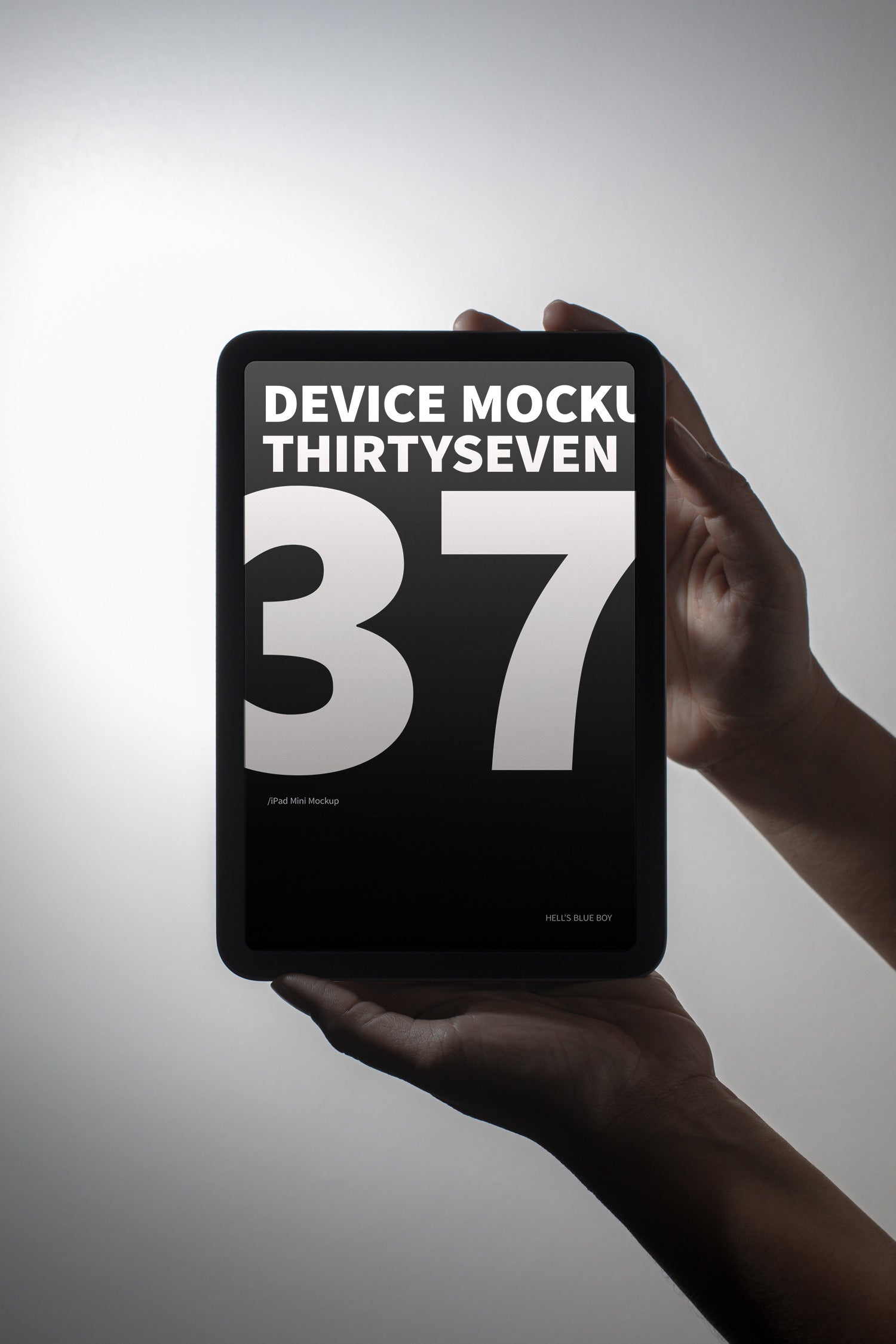 iPad Mini mockup held in hand against a light background.