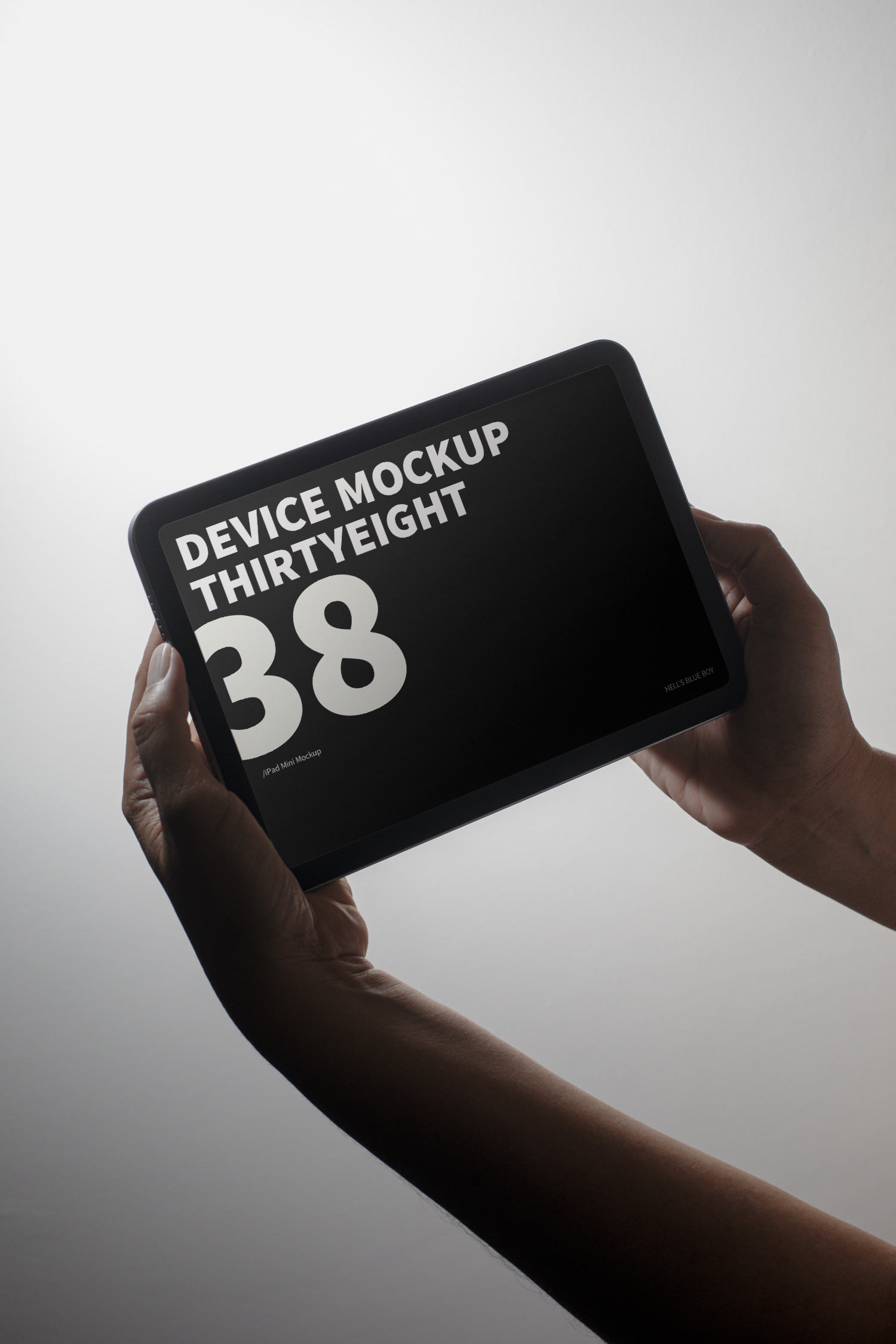 iPad Mini mockup held in hand against a light background.