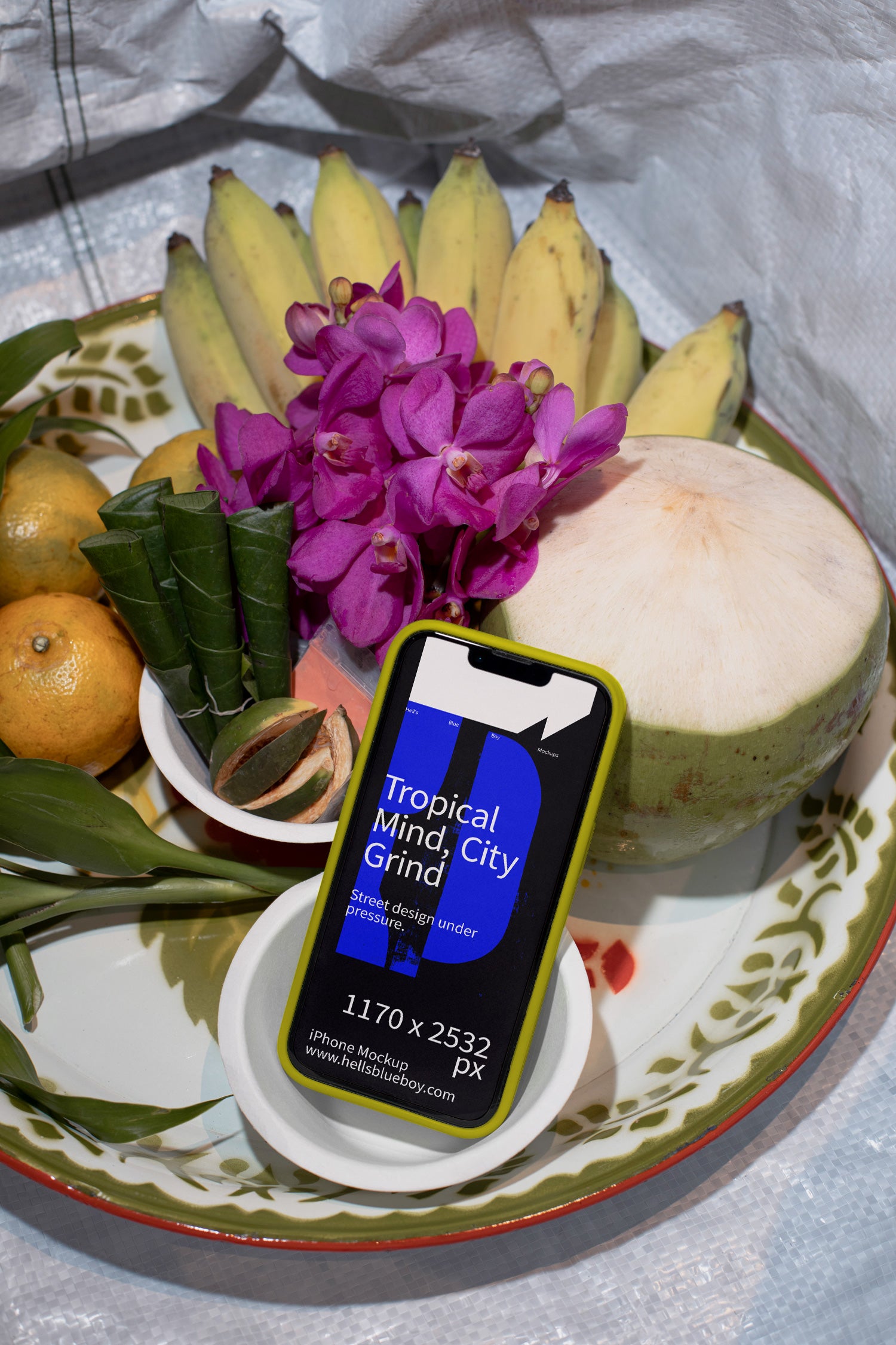Photorealistic iPhone mockup with a rubber case placed on a traditional fruit offering. Designed for app previews, UI layouts, and digital branding.