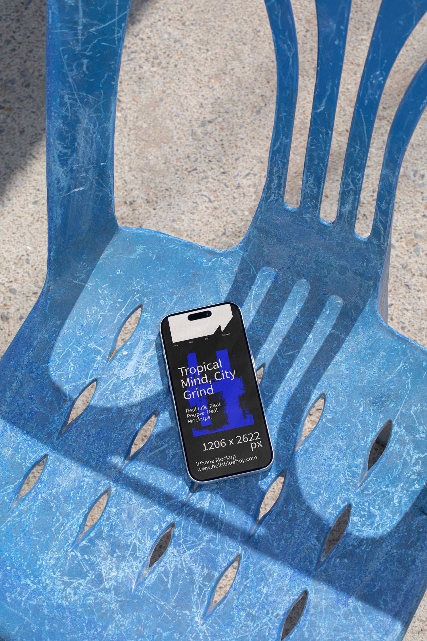 iPhone mockup lying on a blue plastic chair with strong shadows. Ideal for showcasing app screens, UI design, and mobile branding visuals.