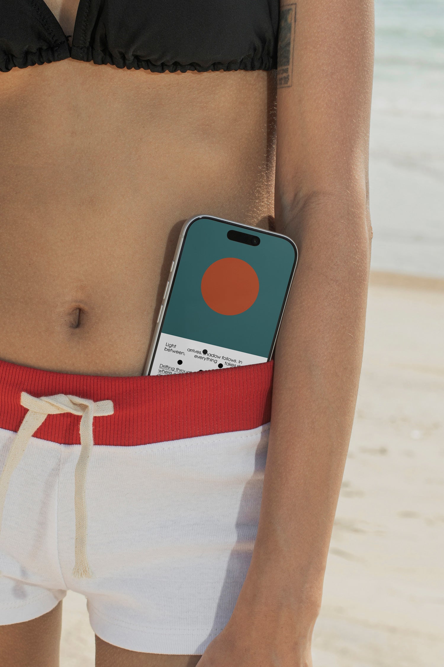 iPhone mockup tucked into bikini bottoms at the beach. Built for showcasing app interfaces, branding, wallpapers, social media concepts, and digital presentations.